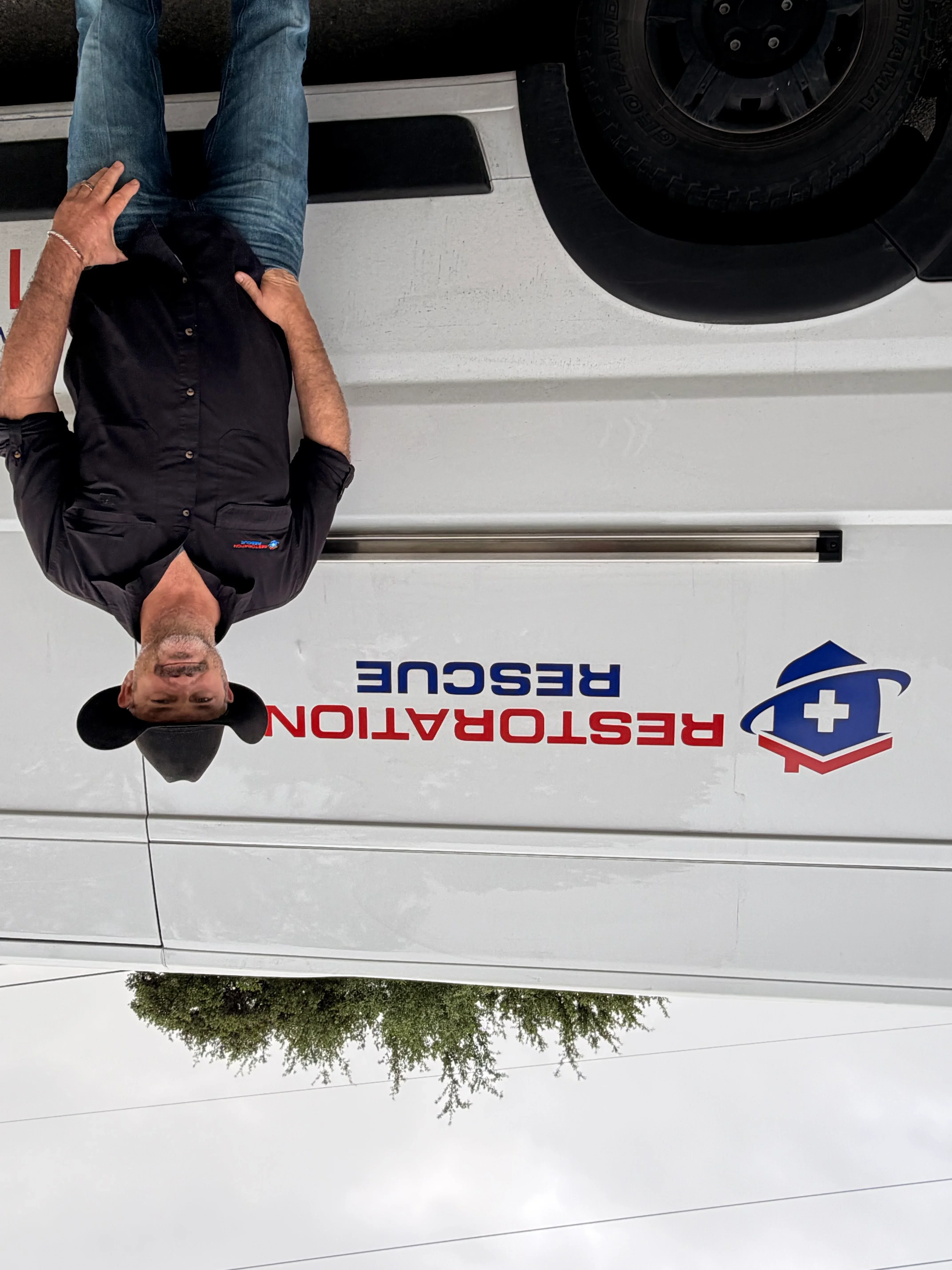 Custom vinyl wrap with red and blue branding on white service vehicle door